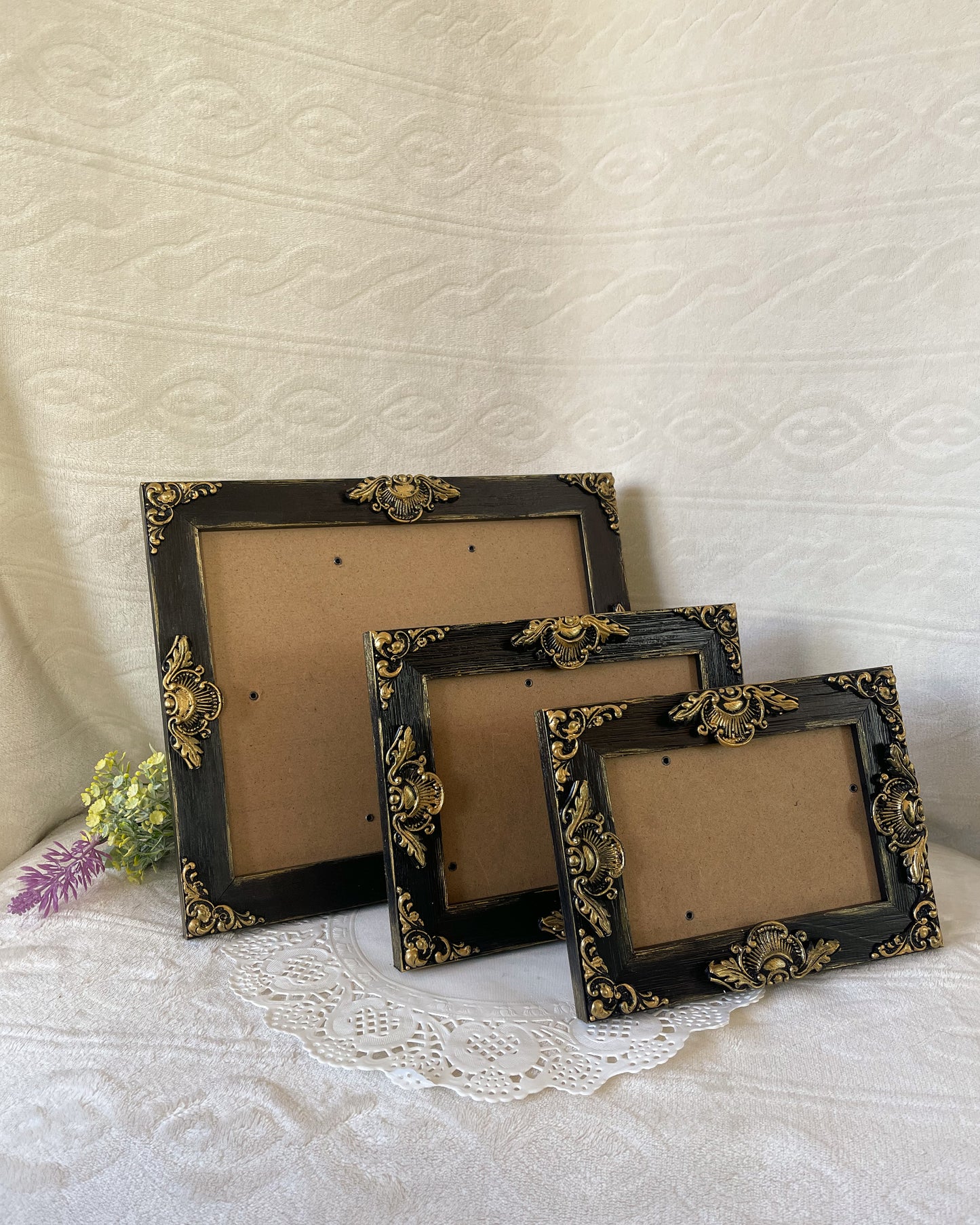 Solid wood ornate picture frame painted black and accented with gold